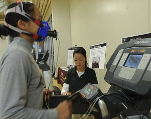 Technician monitoring a woman performing a the VO2 Max research test.