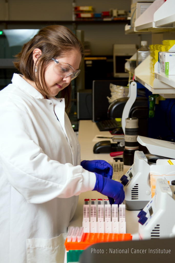 Woman researcher reaching for a slide